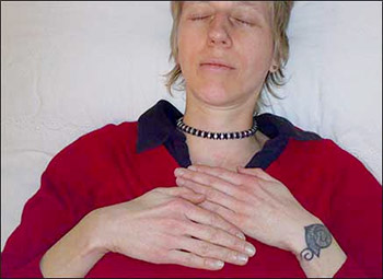 Brighton Reiki practitioner giving herself a Reiki treatment