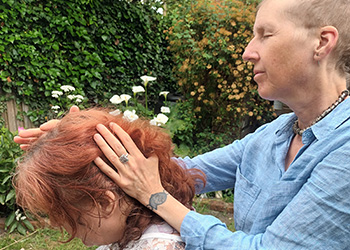 Isla enjoying a summer mobile Indian head massage in her garden in Brighton